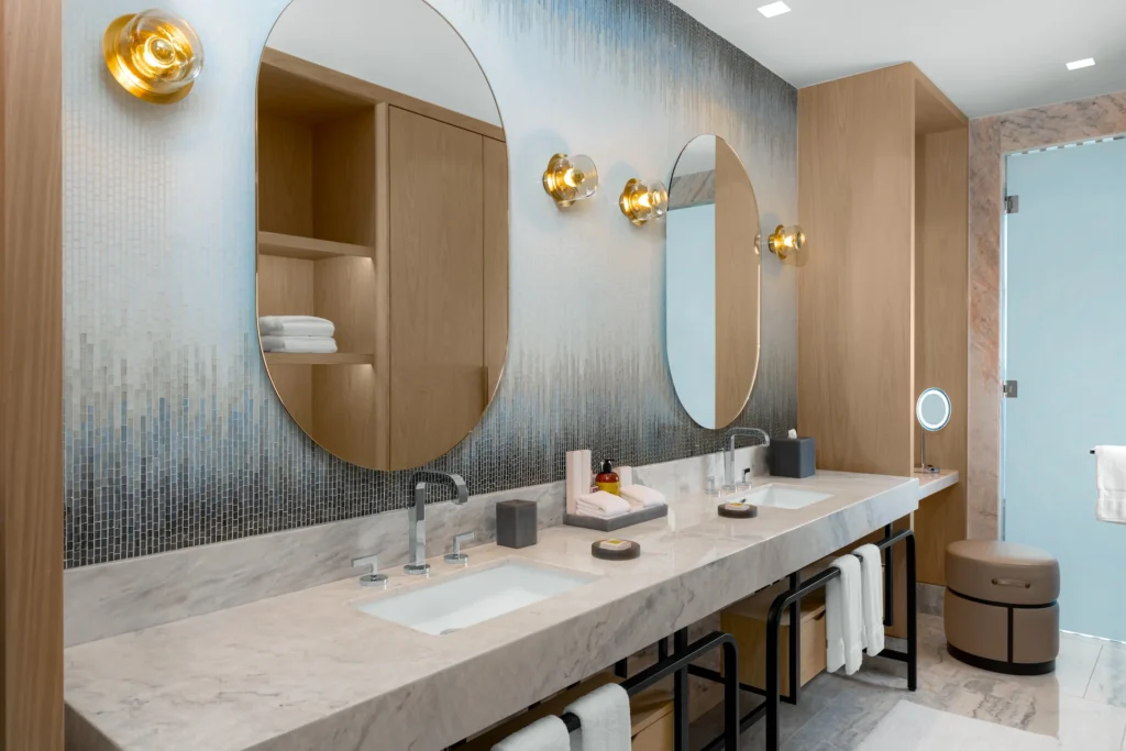 Bathroom with double sinks in the DELUXE OCEANFRONT KING BED GUESTROOM, featuring elegant design and modern amenities