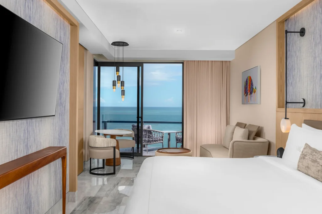 Ocean-view bedroom in the DELUXE OCEANFRONT KING BED GUESTROOM, offering a serene ambiance with elegant décor