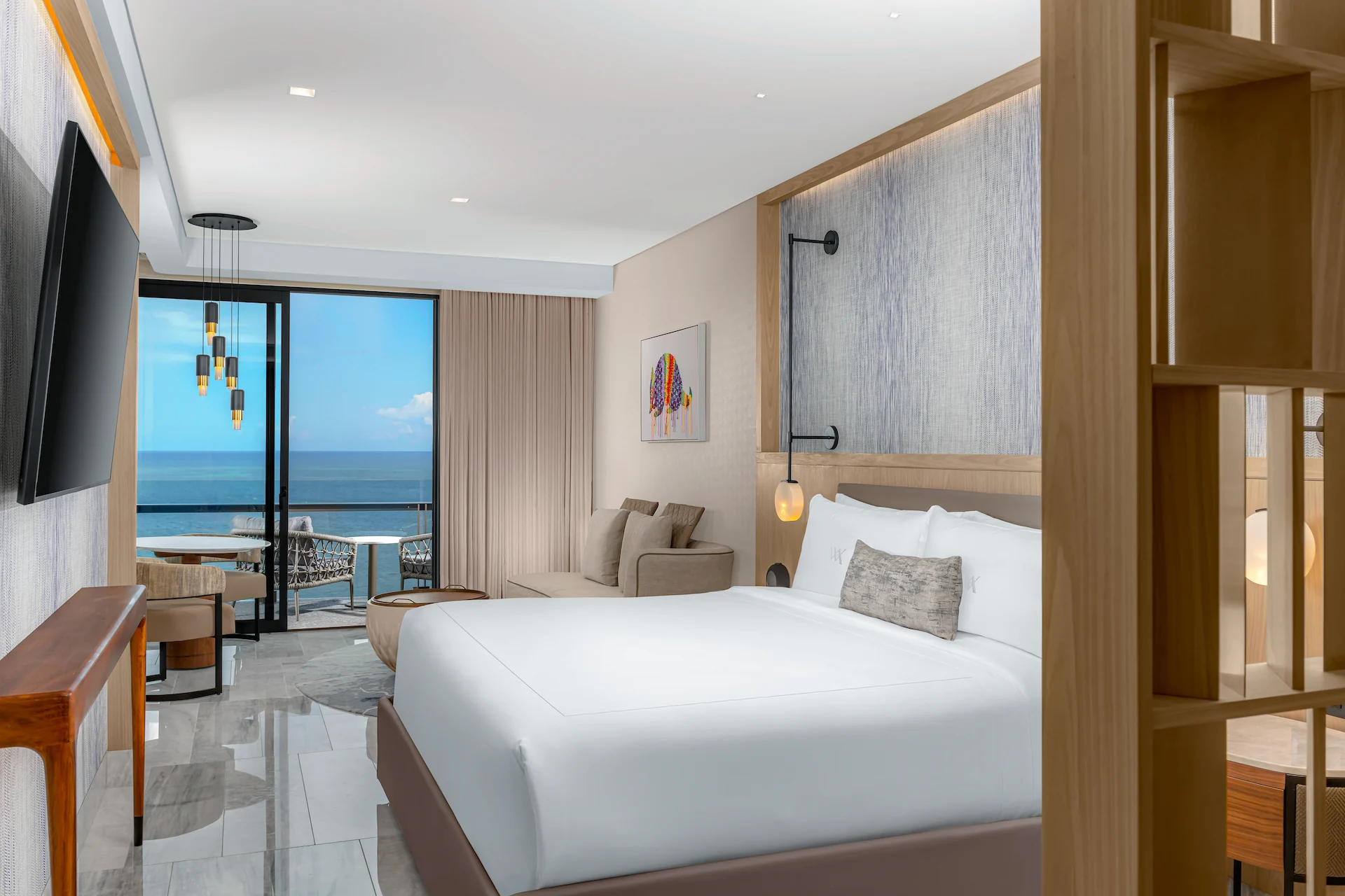 Ocean-view bedroom in the DELUXE OCEANFRONT KING BED GUESTROOM, featuring refined décor and a tranquil ambiance