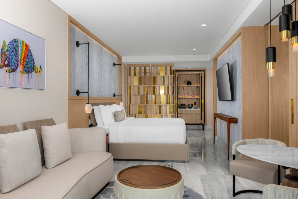 Living area and bedroom in the 1 KING MOBILITY ACCESSIBLE ROOM with roll-in shower, designed for comfort and accessibility with stylish, spacious interiors