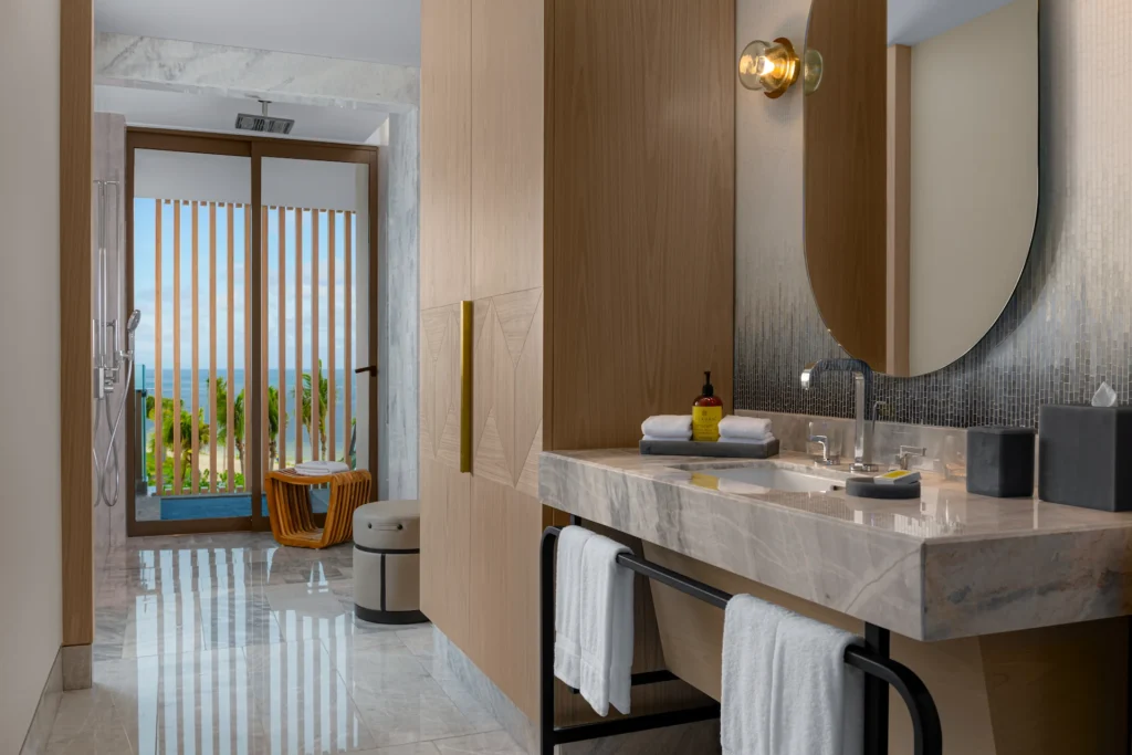 Bathroom with accessible roll-in shower and ocean views in the 1 KING MOBILITY ACCESSIBLE ROOM, offering a comfortable and inclusive design