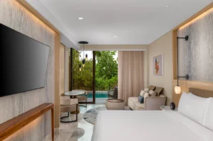 Elegant interior of SWIM UP POOL 1 KING GUESTROOM featuring a stylish design with direct pool access and tranquil surroundings