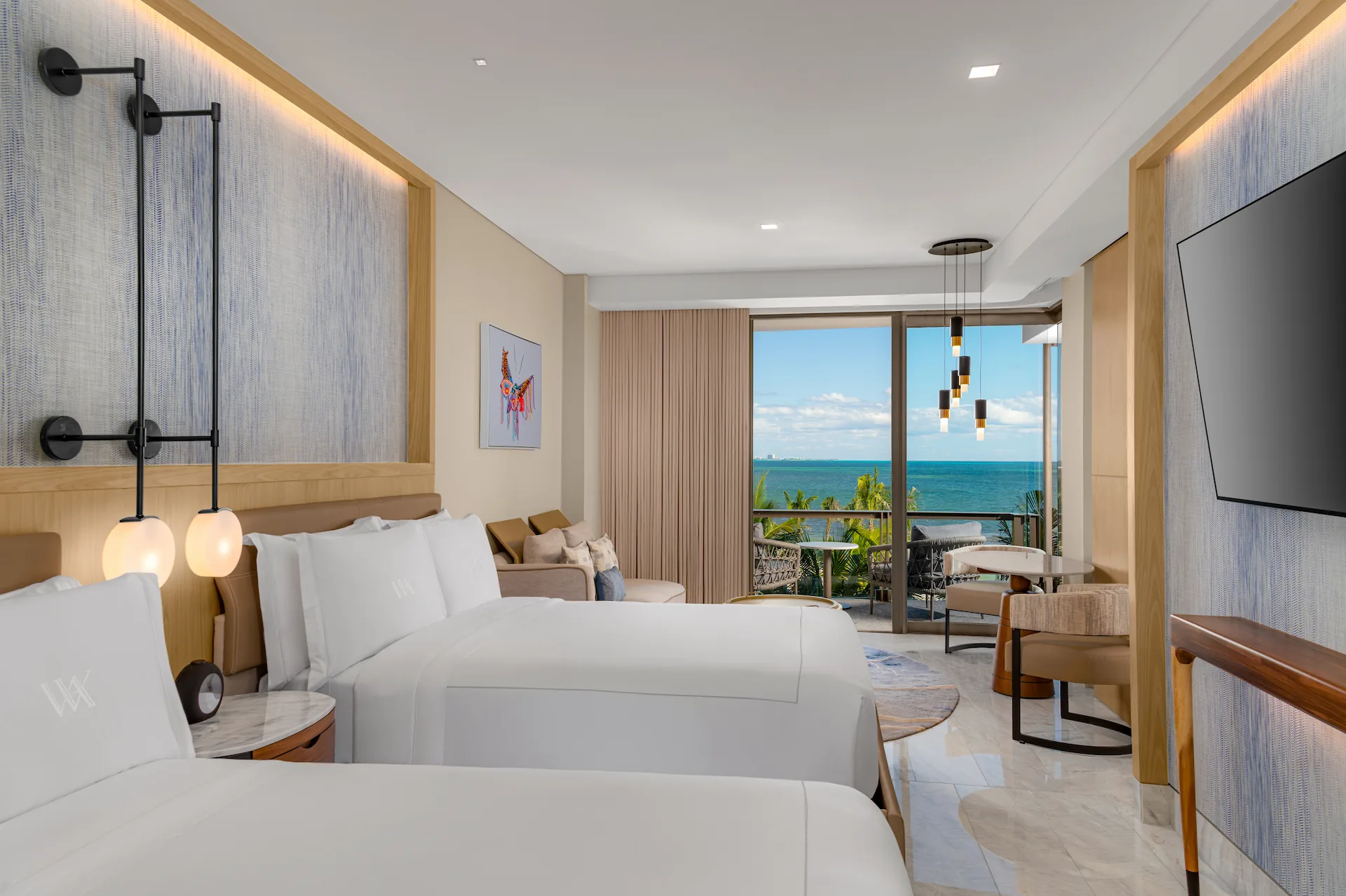 Spacious interior of OCEAN FRONT 2 QUEEN BEDS GUESTROOM, offering stunning ocean views and a comfortable, modern design