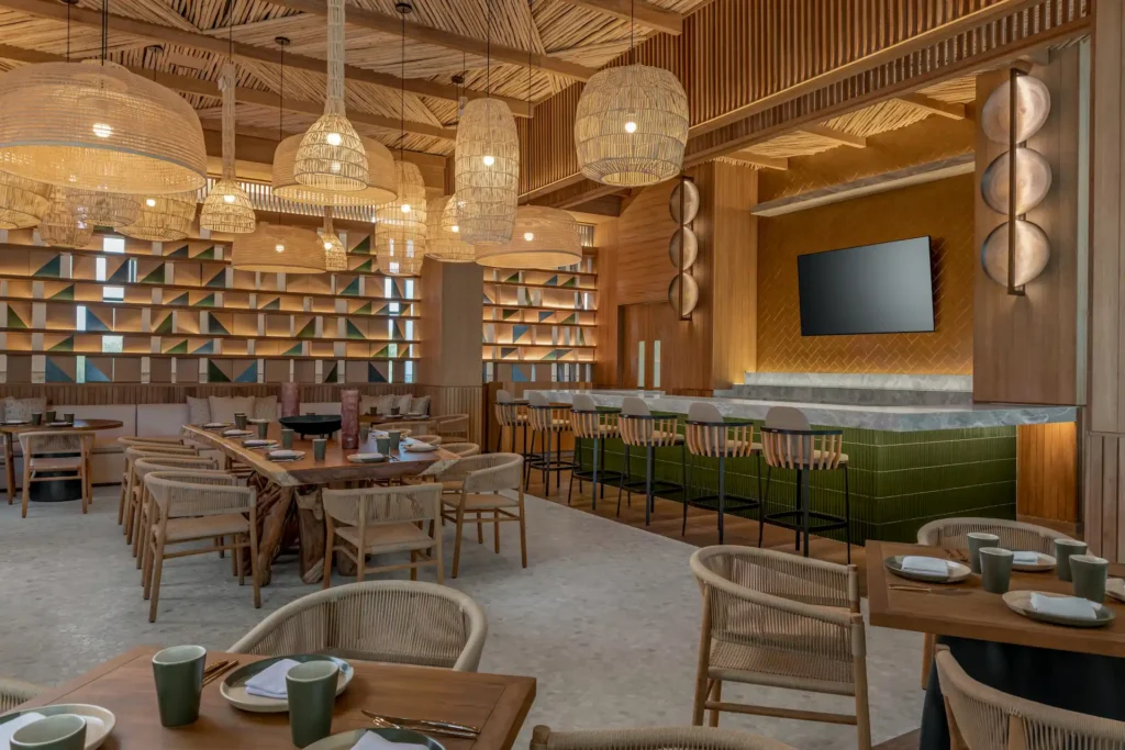 Elegant interior of JA’O featuring stylish tables, chairs, and a sophisticated bar.