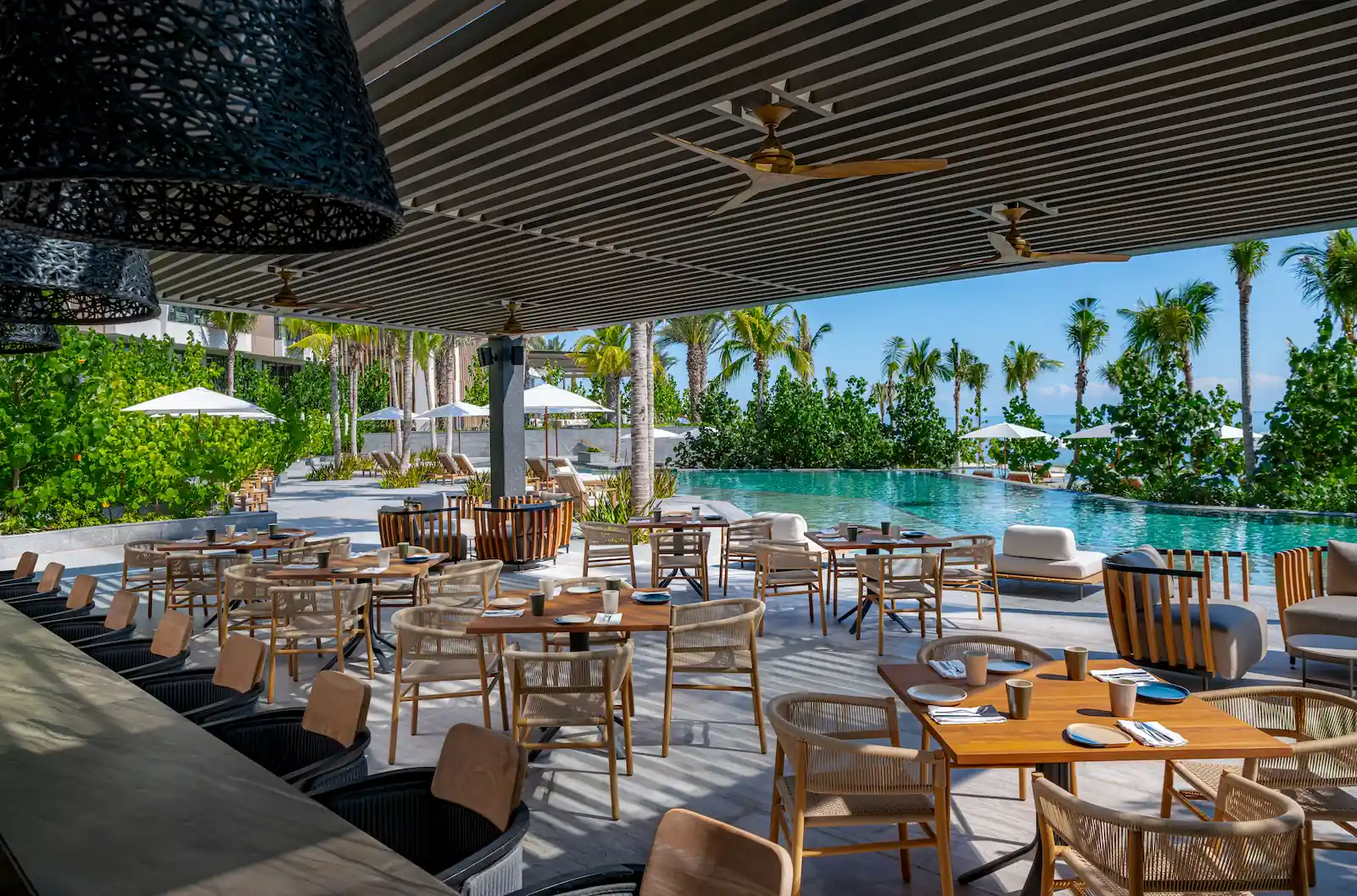 Scenic view of the pool bar terrace and infinity pool at Waldorf Astoria Cancun – Relax and unwind in paradise.
