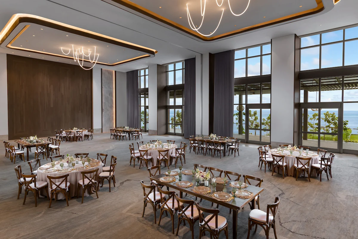 Grand ballroom with crystal chandeliers, polished floors, and opulent decor, ideal for events