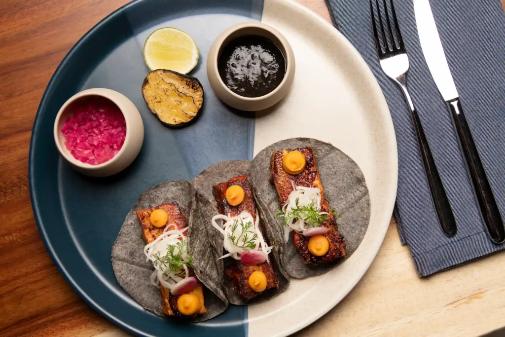 Fluffy pancakes with crispy bacon and sauces, beautifully served at JA’O