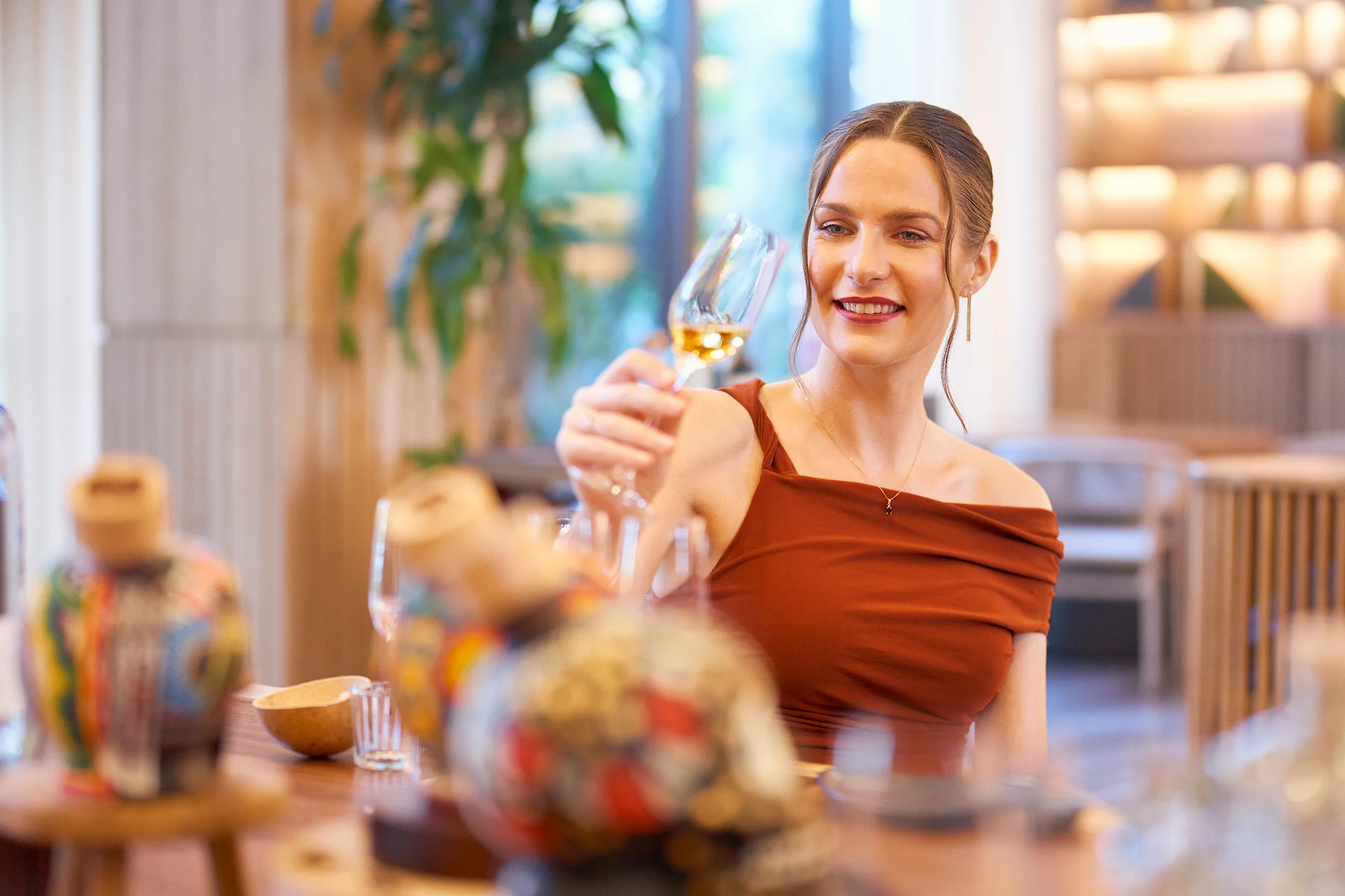 An elegant woman enjoying a glass of champagne at Waldorf Astoria, exuding sophistication.
