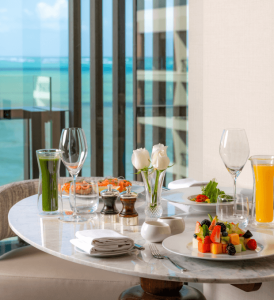 A delicious and luxurious breakfast served on an elegant marble table, with stunning views visible through the window.