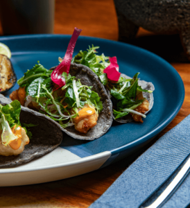 A delicious plate of Mexican tacos served at Jao restaurant in Waldorf Astoria, showcasing authentic flavors in an elegant setting.
