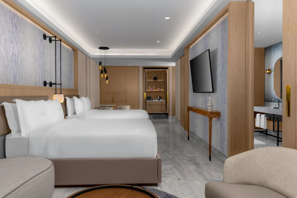 Stylish bedroom in the DELUXE OCEAN FRONT 2 QUEEN BEDS GUESTROOM, featuring modern décor and comfort.