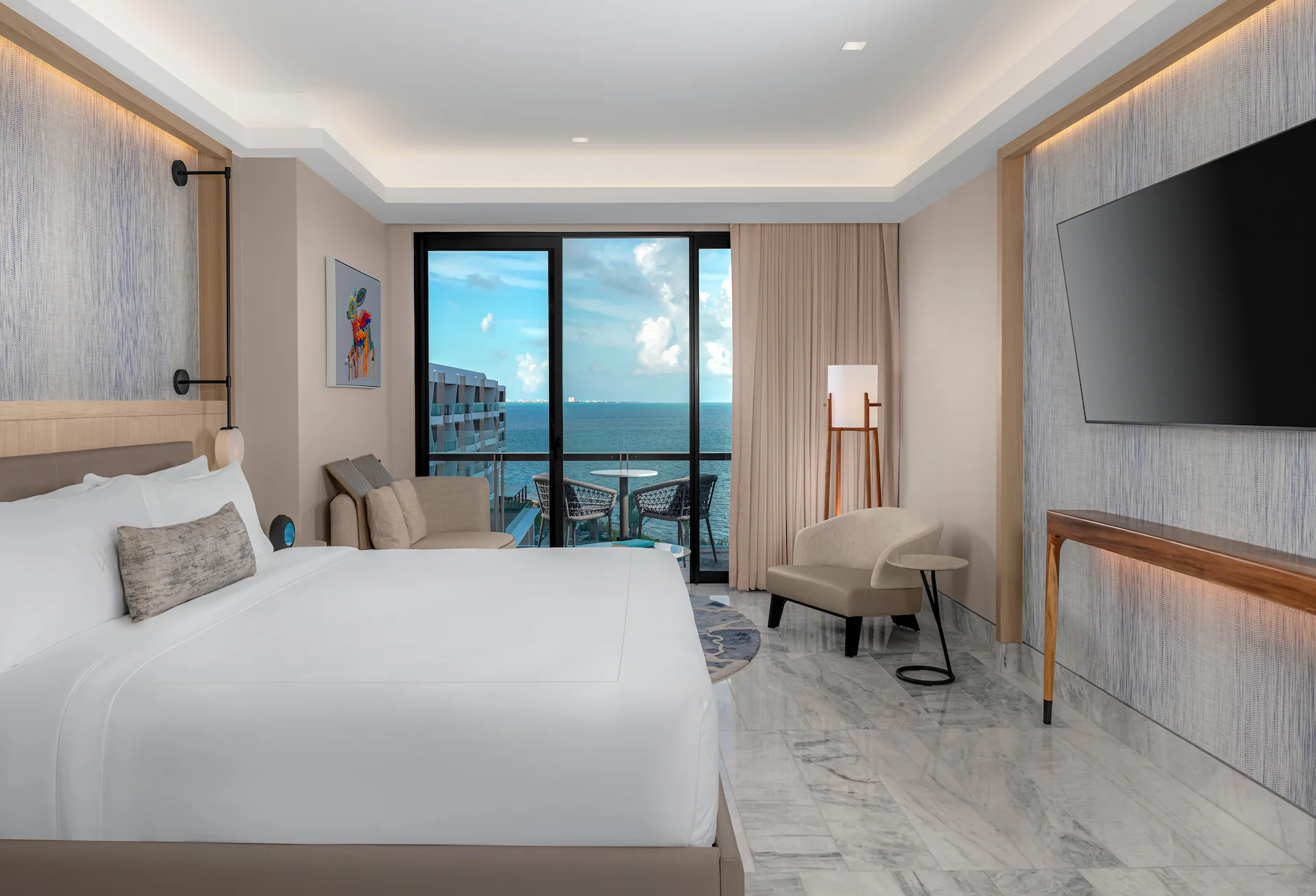 Elegant bedroom in the DELUXE OCEANFRONT SUITE WITH KING BED, featuring luxurious décor and stunning ocean views