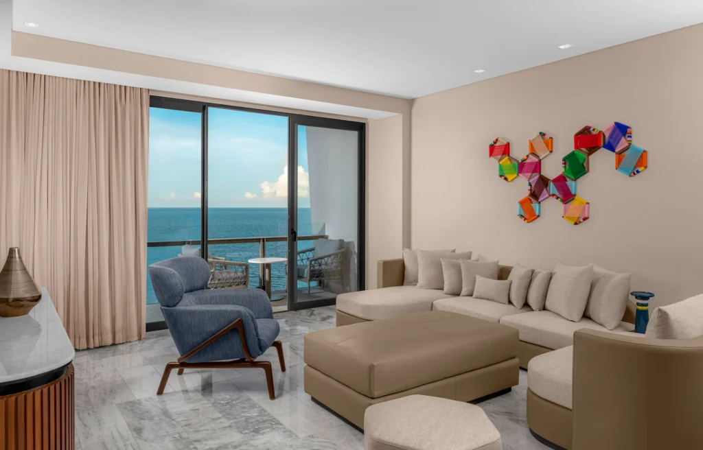 Spacious living room in the DELUXE OCEANFRONT SUITE WITH KING BED, featuring stylish furnishings and breathtaking ocean views