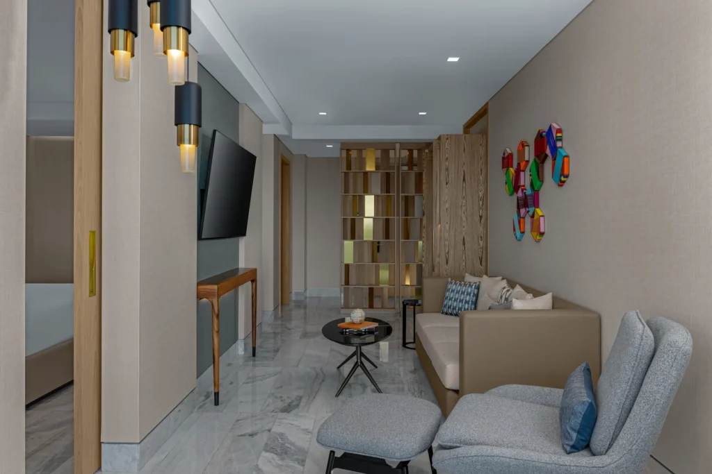 Luxurious Ocean Front Suite living area at Waldorf Astoria Cancun, with modern TV and comfortable seating