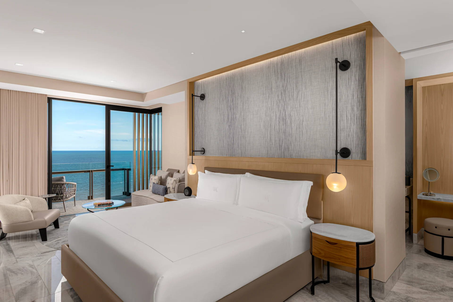 Interior of the Ocean Front Suite with King Size Bed at Waldorf Astoria Cancun, luxurious design with ocean view