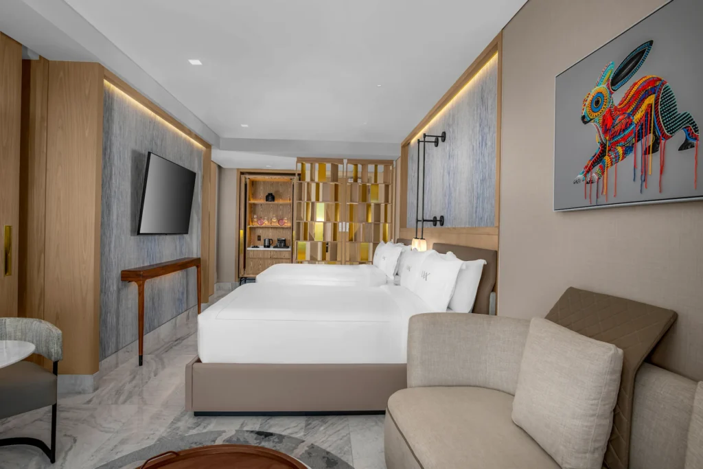 Elegant bedroom in the DELUXE OCEAN FRONT 2 QUEEN BEDS GUESTROOM, offering comfort and stylish ocean-inspired décor