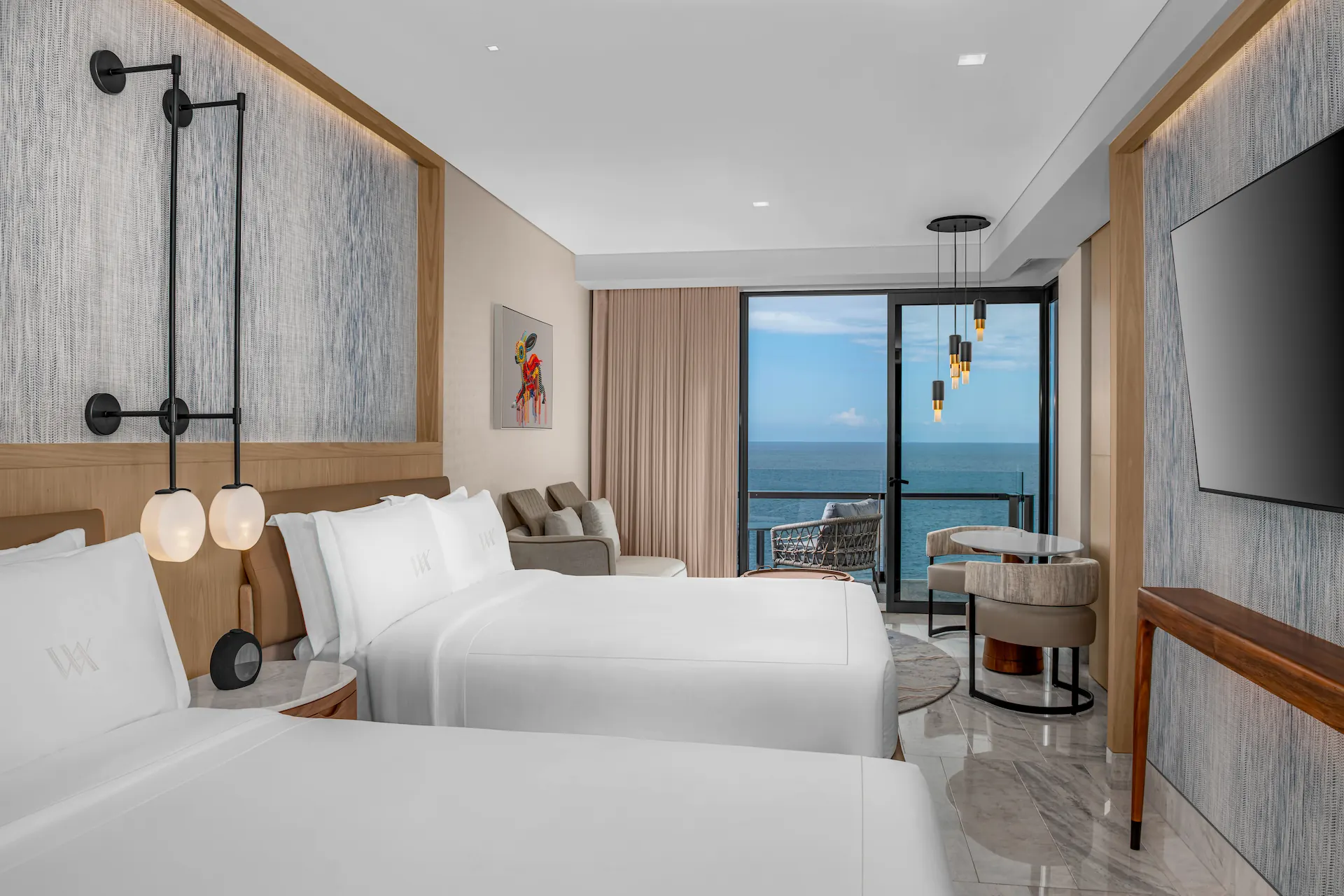 Ocean-view bedroom in the DELUXE OCEAN FRONT 2 QUEEN BEDS GUESTROOM, featuring elegant décor and a tranquil atmosphere