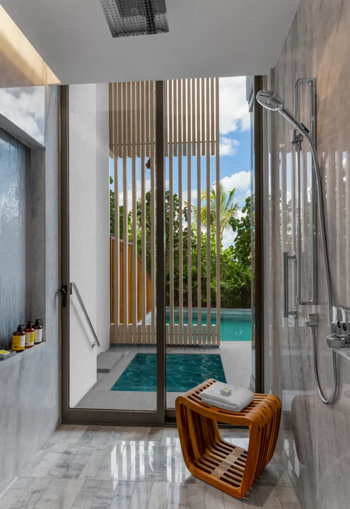 Luxury bathroom in SWIM UP POOL TWO QUEEN BED GUESTROOM at Waldorf Astoria Cancun with private pool access and elegant marble details