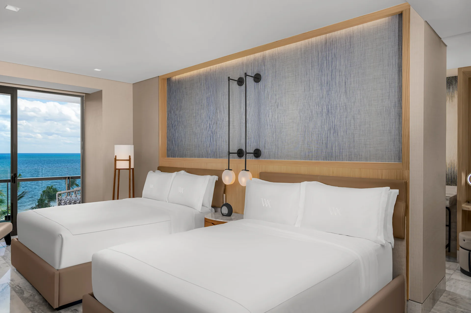 Luxurious interior of OCEANFRONT SUITE WITH 2 QUEEN BEDS at Waldorf Astoria Cancun, featuring elegant décor and breathtaking ocean views