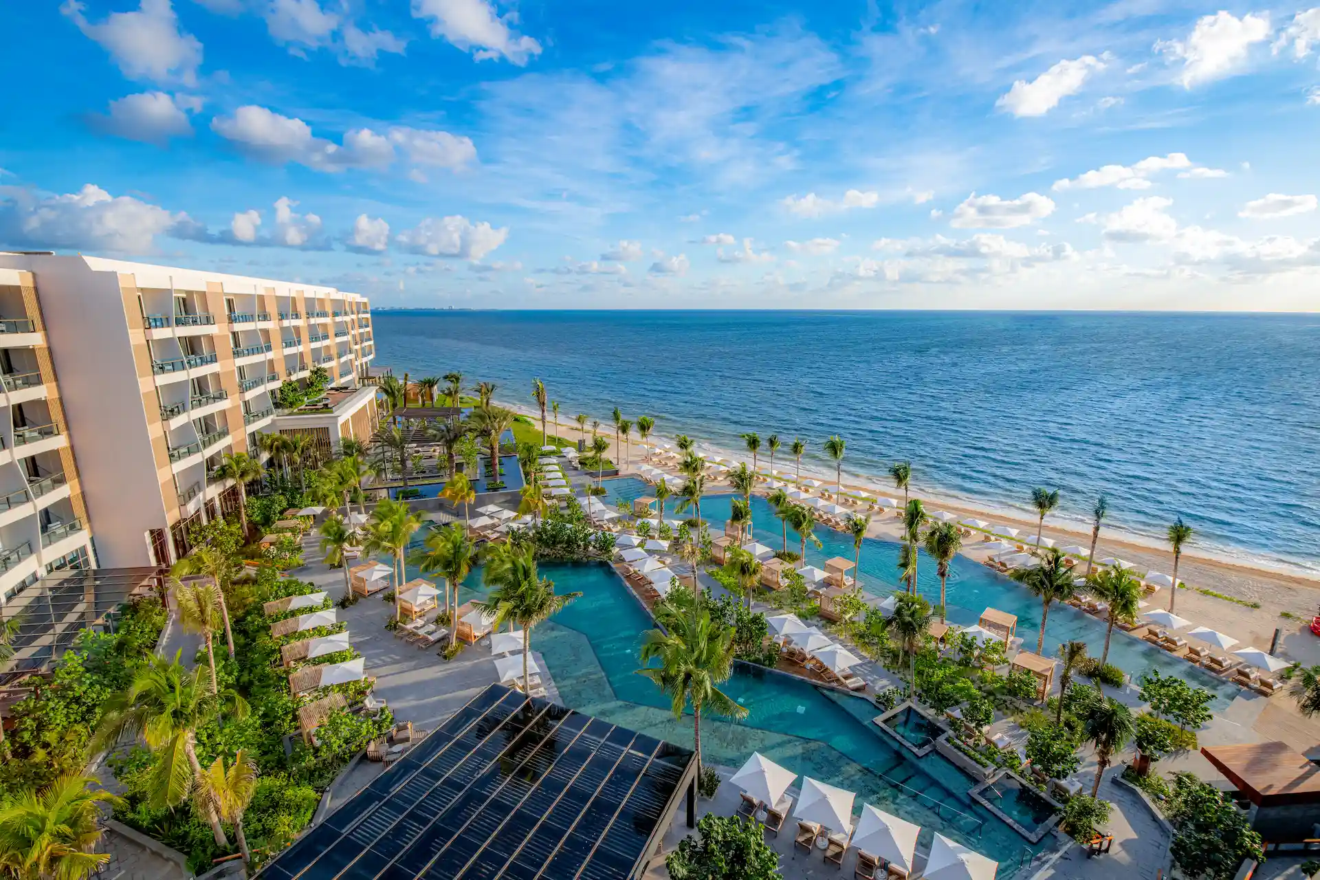 Aerial view of the hotel, showcasing its luxurious design, beachfront location, and stunning surroundings.