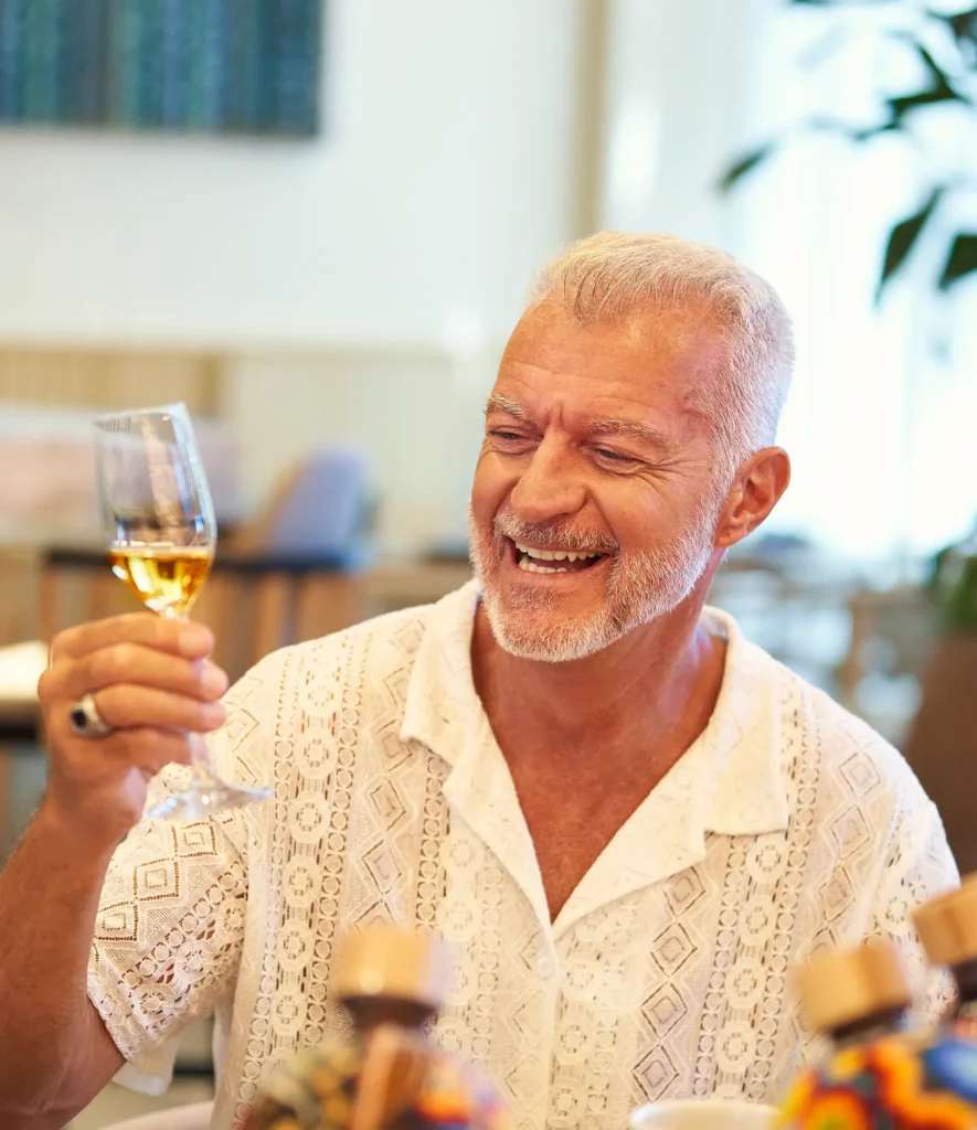 Senior man enjoying the AARP Members Save discounts at Waldorf Astoria, experiencing luxury and exclusive benefits.