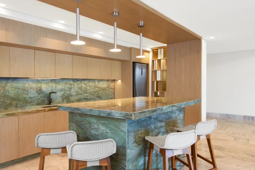 Modern kitchen with an island in the AMAI Suite, offering a sleek design and a functional space for cooking and entertaining