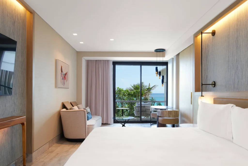 Ocean-view bedroom in the AMAI Riviera Suite, featuring elegant décor and a tranquil, inviting ambiance.