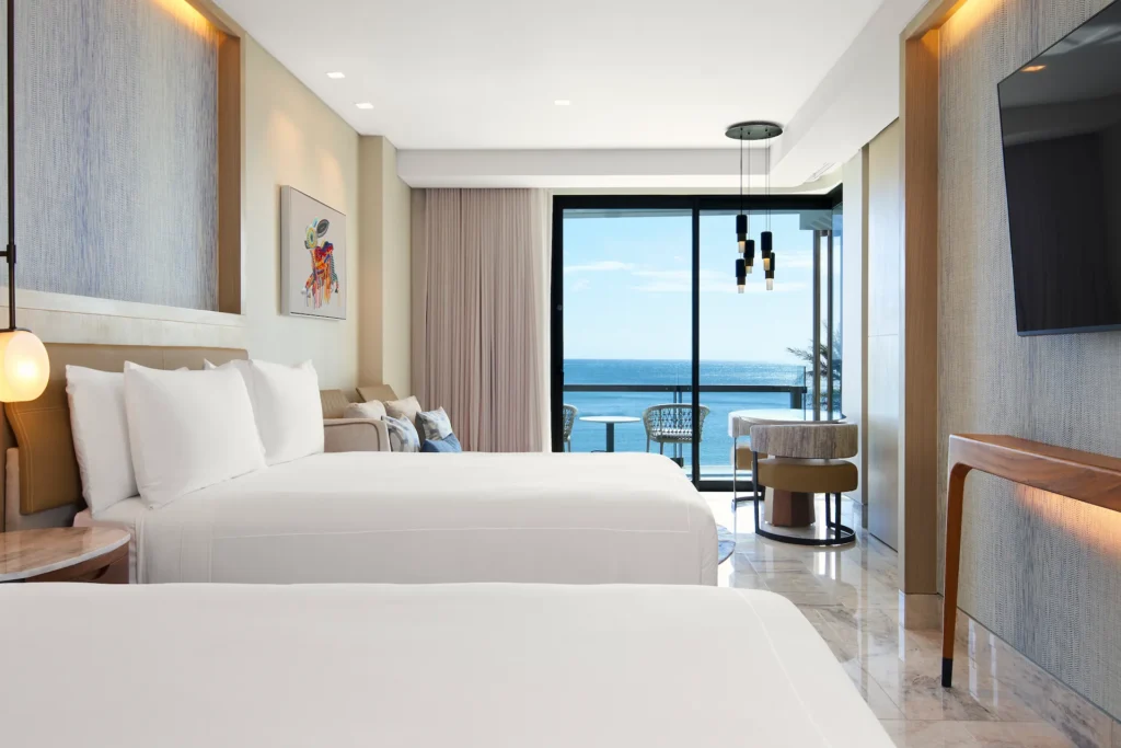 Ocean-view bedroom in the AMAI Suite, offering refined décor and a peaceful, luxurious setting