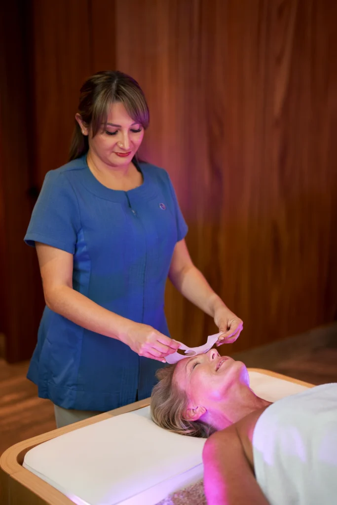 Woman experiencing a beauty treatment at the Waldorf Astoria Cancún, in a tranquil and elegant spa setting.