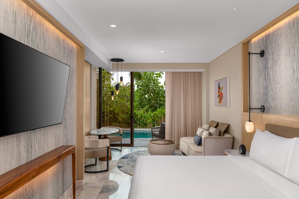 Elegant room with king bed, TV, and private pool access