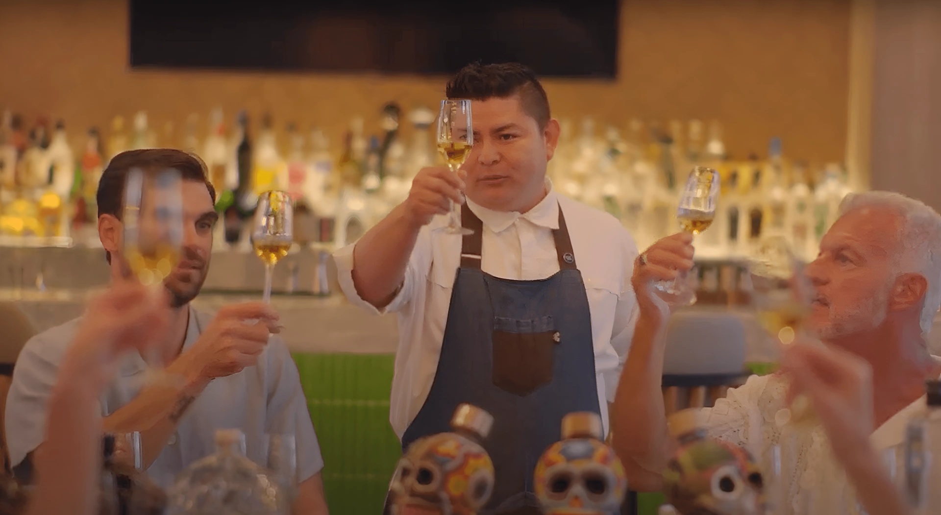 Sommelier at Waldorf Astoria Cancún leading an exclusive mezcal and tequila tasting, showcasing premium selections in an elegant and sophisticated setting.