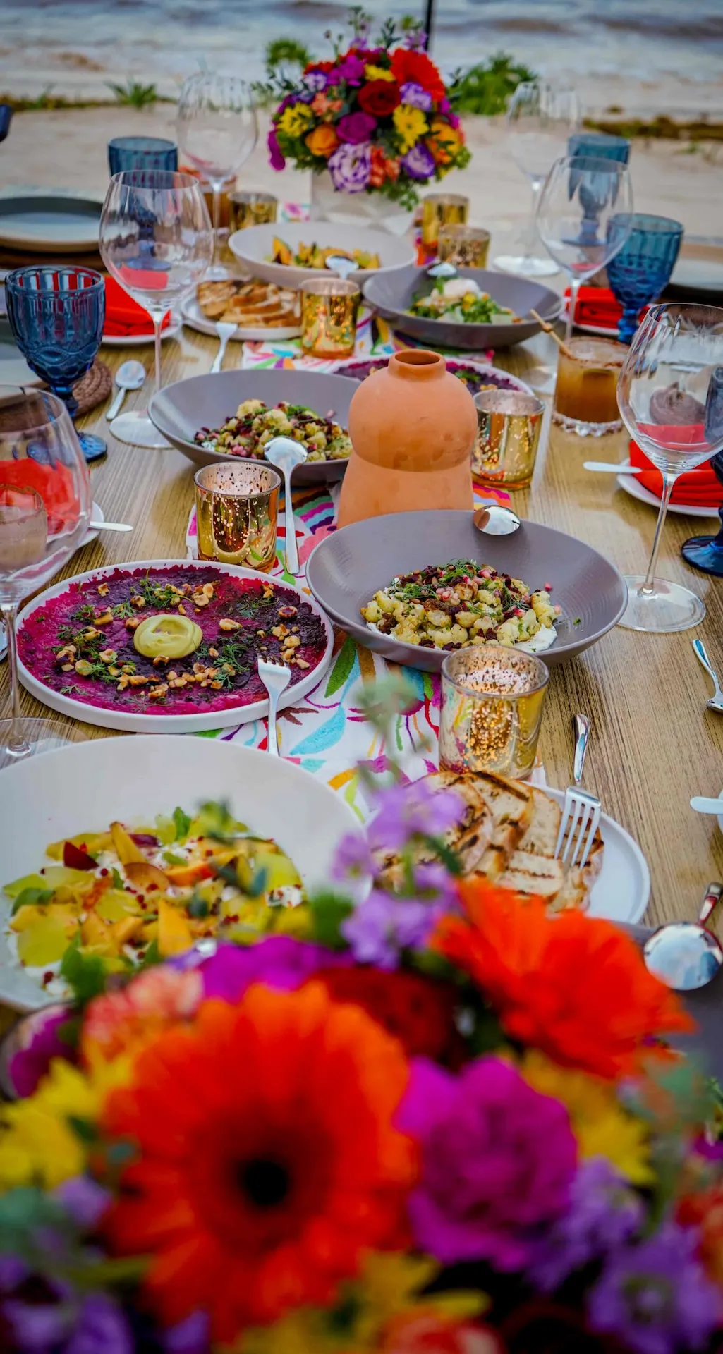 Elegantly set dinner table with fine china, glassware, and candles for a sophisticated dining experience