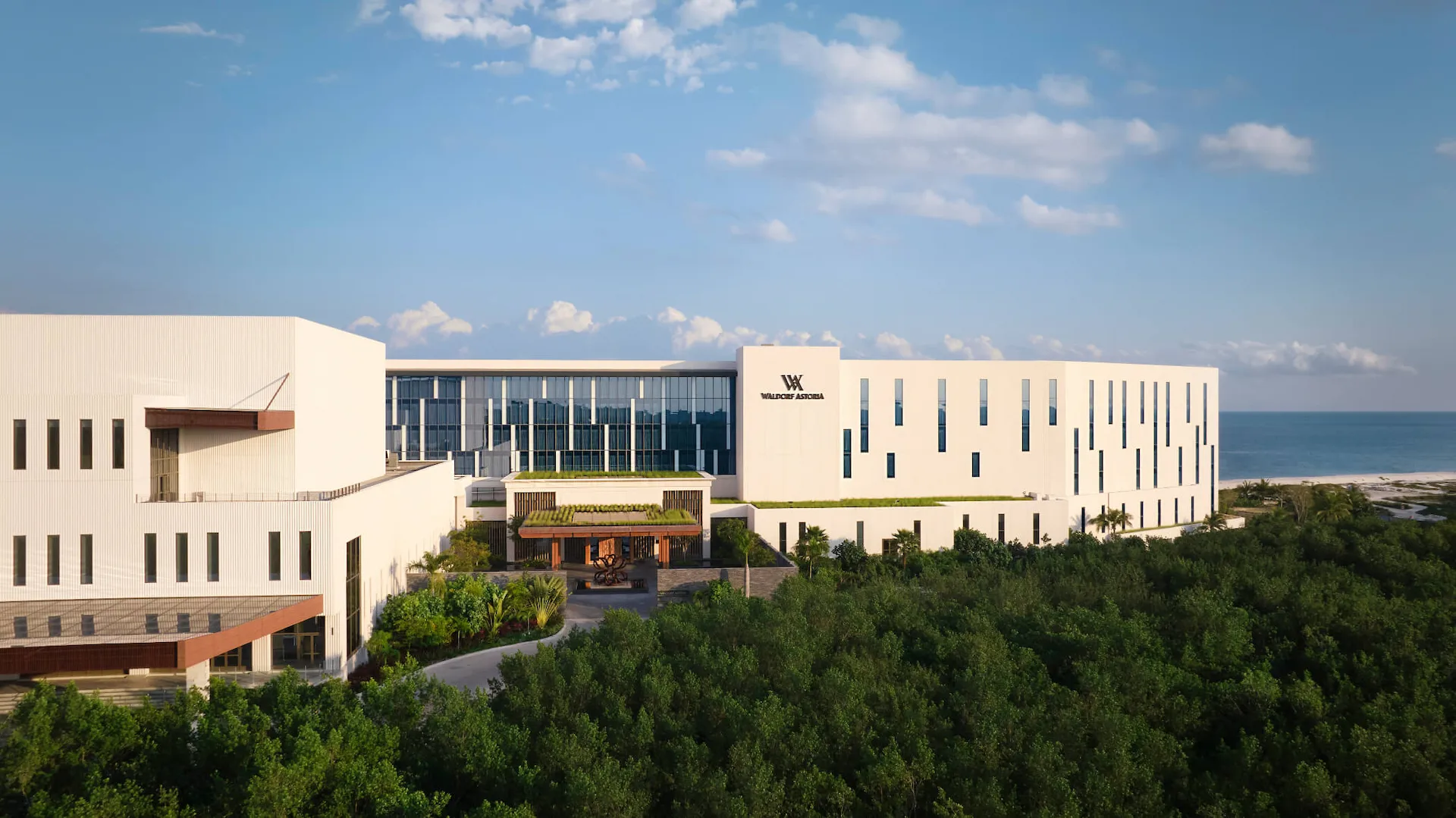 Waldorf Astoria Cancun Hotel exterior, showcasing its architecture and surrounding landscape.
